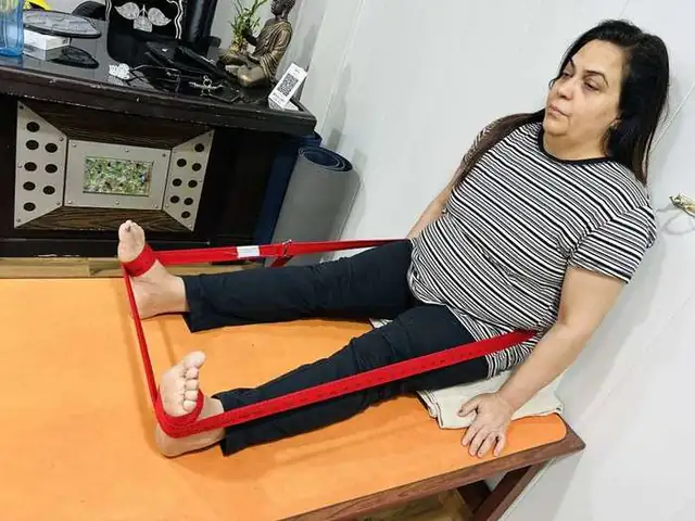 Knee therapy — strap technique on table