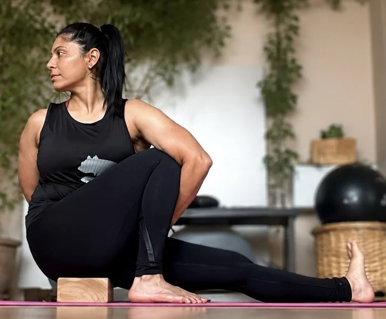 Online personal training session — seated spinal twist